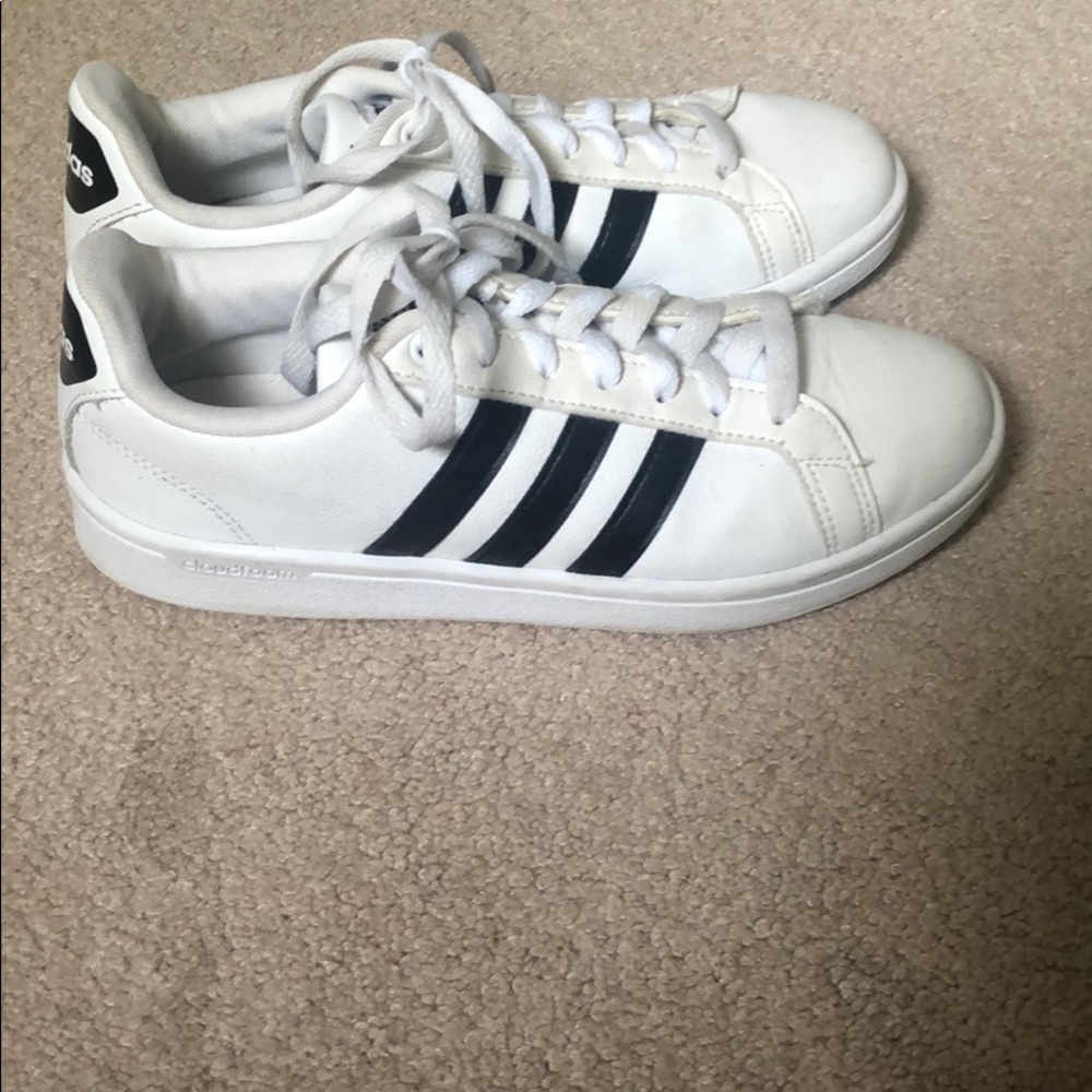 Adidas three striped tennis shoes.